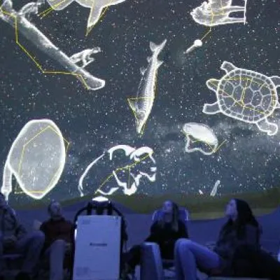 Jasper Planetarium guests viewing First Nations constellations inside The Jasper Planetarium dome theatre